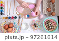 Preparation for Easter. Children's hands paint the egg in a beautiful pink color. Pastel shades. Delicate shades of spring on the palette. Happy Easter 97261614