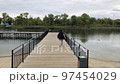 A positive fat woman dances on the bridge of the river in the fall. Mental health.  97454029
