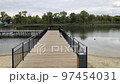 A positive fat woman dances on the bridge of the river in the fall. Mental health.  97454031