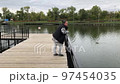 A positive fat woman dances on the bridge of the river in the fall. Mental health.  97454035