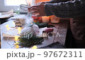 a woman sprinkles homemade stollen with powdered sugar on the table in slow motion 97672311