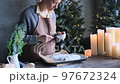 the girl sprinkles powdered sugar on the Christmas stollen 97672324