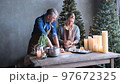 loving husband and wife cook dough together in the kitchen for a Christmas cake. 97672325