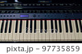 Piano keyboard slow panning over black and white keys 97735859