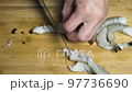 Japanese chef cooks shrimp for tempura 97736690