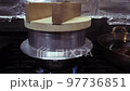 Cooking rice in a traditional Japanese pot 97736851