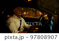 Tired male driver touching face and neck during ride 97808907