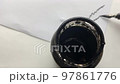 Bank with ink and pen. In the video, a jar of black ink stands in the foreground, and a man writes with a pen on paper in the background. 97861776