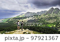 Go everywhere. A man and a woman admire the mountain landscape, hiking, alpine landscape, unity with 97921367