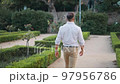 Anonymous businessman walking in park 97956786