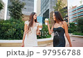 Diverse girlfriends drinking coffee after shopping 97956788