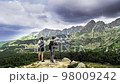 beauty of mountain landscapes and the adventure of hiking. Follow a woman as she treks through 98009242