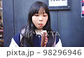 チョコバナナを食べる小学生の女の子の動画素材 [98296946]