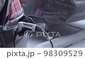 electric powered car in garage as man removes charging cable from vehicle electric car industry future drive modern 98309529
