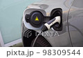 Electrical car recharging Modern electric car charging at the charger station, Electrical nozzle is inserted into an electrocar 98309544