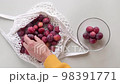 Man takes fresh ripe Plums out from reusable grocery bag with fruits 98391771