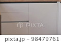 Tilt closeup shot of modern white and wooden beige kitchen interior 98479761
