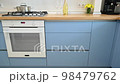 Modern blue-teal and white kitchen interior 98479762