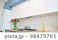 Modern blue-teal and white kitchen interior 98479765