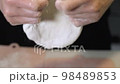 Roll out the fermented pizza dough with your hands 98489853
