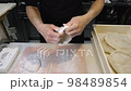 Roll out the fermented pizza dough with your hands 98489854