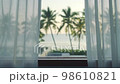 View of a tropical beach. Point of view watching through a glass window. Beautiful sunset with calm and relax feel. Beach and coconut tree at background. Pool Villa in front. 98610821