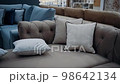 A brown sofa with beige cushions filmed in slow motion. 4k video 98642134