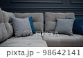 Slow shot of a gray couch with two gray and two blue pillows. 4k video 98642141