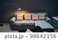 Living room decorated in a modern style with a gray sofa and decorative pillows, lit by a tall lamp on the right. 4k video 98642156