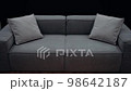 A simple gray sofa with cushions of the same color, shot slowly on a black background. 4k video 98642187