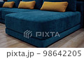 Dark blue smooth sofa model with long yellow cushions. 4k video 98642205