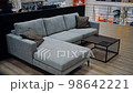 Model of a comfortable gray sofa with two brown pillows in a shopping center. Coffee table. 4k video 98642221
