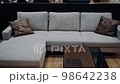 Gray sofa with two brown leather pillows in the office, next to a small black table. 4k video 98642238