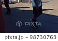 People Walking By At The Fair In The Shade 98730763