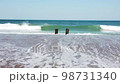 Waves Crashing Against a Old Torn Down Dock On The Sand 98731340