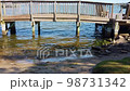 Small Waves Passing By Under Wooden Bridge With rocks 98731342