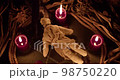 A voodoo ritual with a scary doll. Close-up shot. 98750220