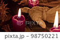 Occultist dripping hot wax on voodoo doll, magic rituals, black spell, horror. 98750221