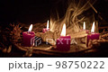 A voodoo ritual with a scary doll. Close-up shot. 98750222