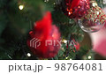 Blurred Christmas tree decorated with red balls 98764081