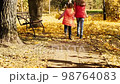 Playful blonde girls in autumn. Autumn Forest or Park. 98764083
