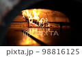 Cooking Neapolitan pizza in a traditional wood-fired oven. Cook pulls out of the oven ready pizza 98816125
