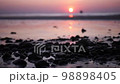 Beautiful view sunset over sea, ocean waves crashing on a stones beach 98898405