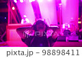 Beautiful woman clubbing at disco party. Portrait of charming female person dancing on neon lights background. 98898411