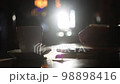 Close up of man's hands at restaurant using smartphone. Man using using digital display touch screen device in cafe and drinks coffee in sunny day 98898416