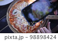 Technology, peoplem photo and food concept. Top view of man hands taking picture of pizza with using smartphone. 98898424