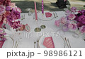 Close-up of wedding table decorated with pink flowers and candles Close-up of wedding table decorated with pink flowers and candles 98986121
