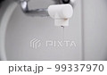 Water droplets dripping from the bathroom faucet 99337970