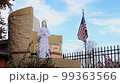 Close up shot of an angel statue with America flag swinging at Texas 99363566