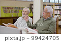 Mature men talking while having lesson in library 99424705